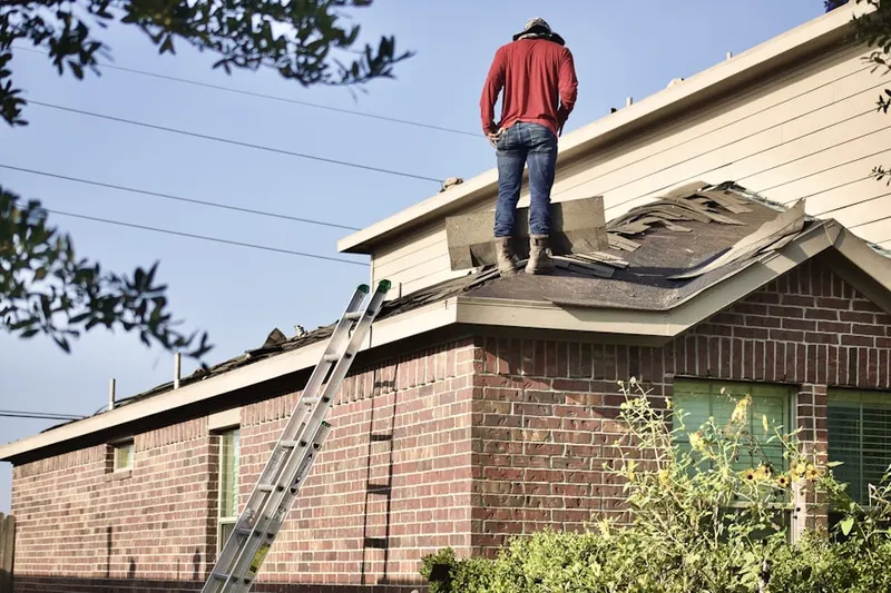 Professional roofer working on a residential roof in Crowley